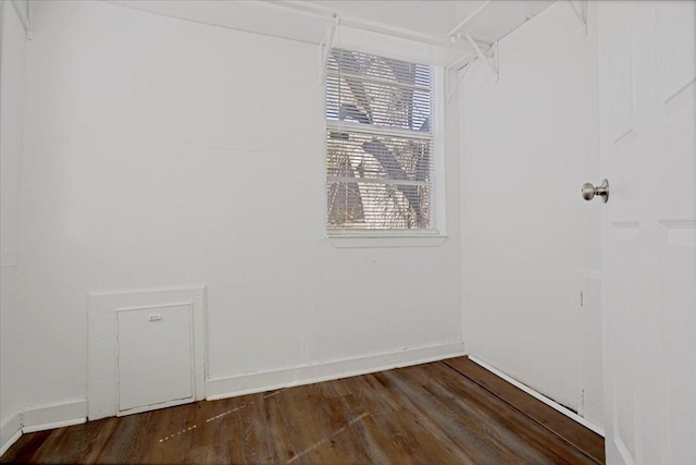 empty room with baseboards and wood finished floors