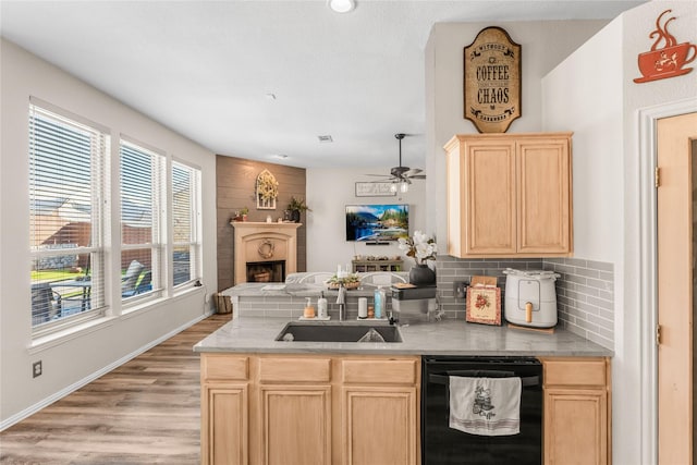 kitchen with tasteful backsplash, light brown cabinetry, dishwasher, light wood-type flooring, and a sink