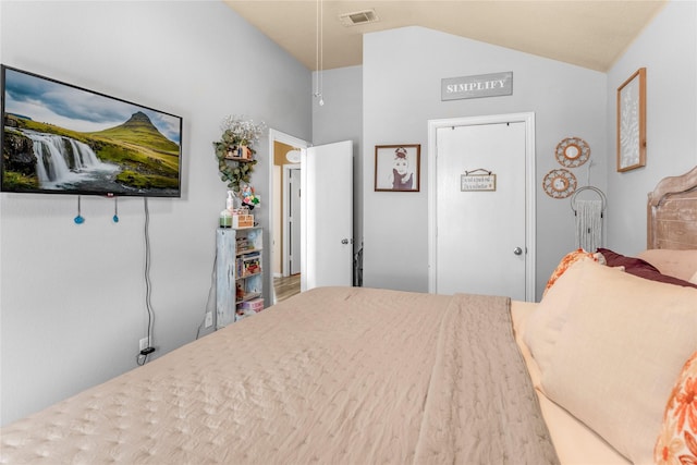 bedroom featuring visible vents, attic access, and vaulted ceiling