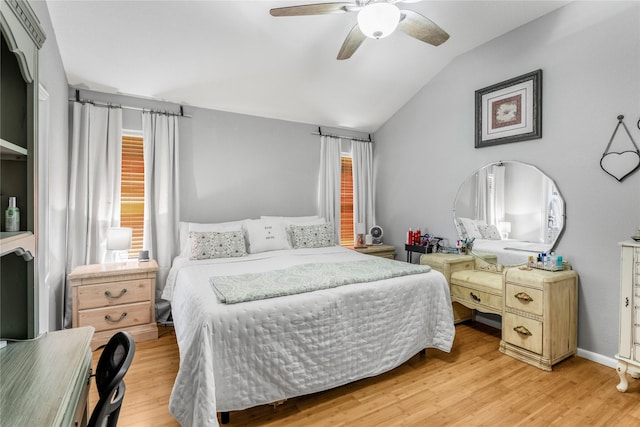 bedroom with multiple windows, lofted ceiling, ceiling fan, and light wood finished floors