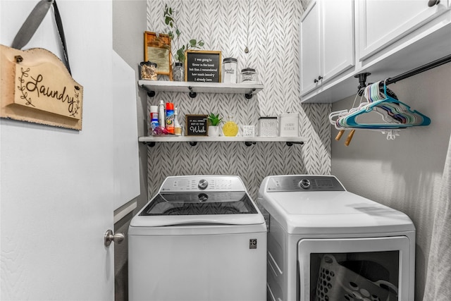 clothes washing area with cabinet space and washer and clothes dryer