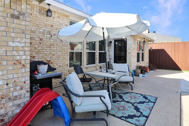 view of patio featuring fence