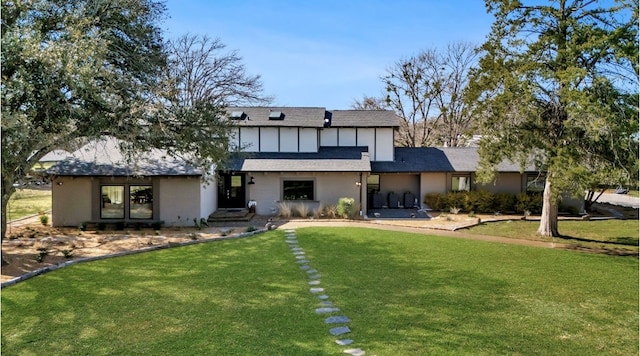 rear view of house featuring a yard and french doors