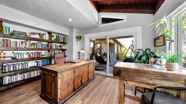 office area featuring beamed ceiling, wooden ceiling, and light wood-style floors