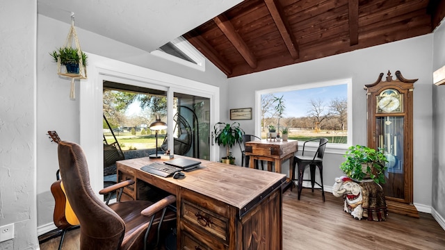 office area with wooden ceiling, a healthy amount of sunlight, wood finished floors, and vaulted ceiling with beams