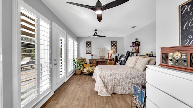 bedroom with visible vents, light wood-type flooring, a ceiling fan, and access to outside