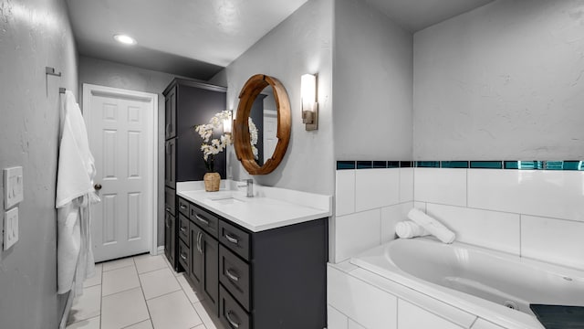 full bathroom with a bath, tile patterned floors, and vanity