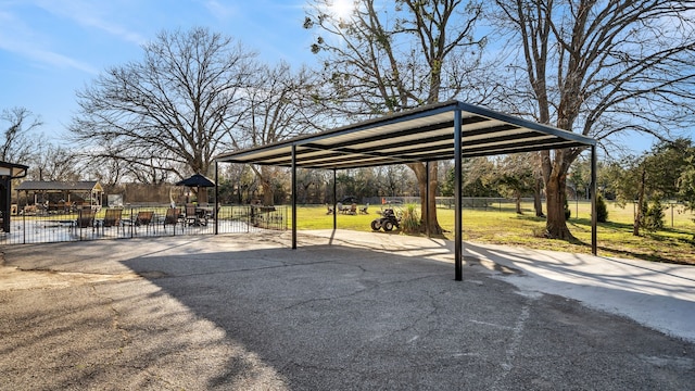 exterior space featuring a detached carport and fence