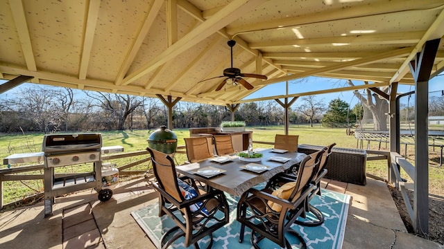 view of patio / terrace with outdoor dining space, a lanai, and a ceiling fan