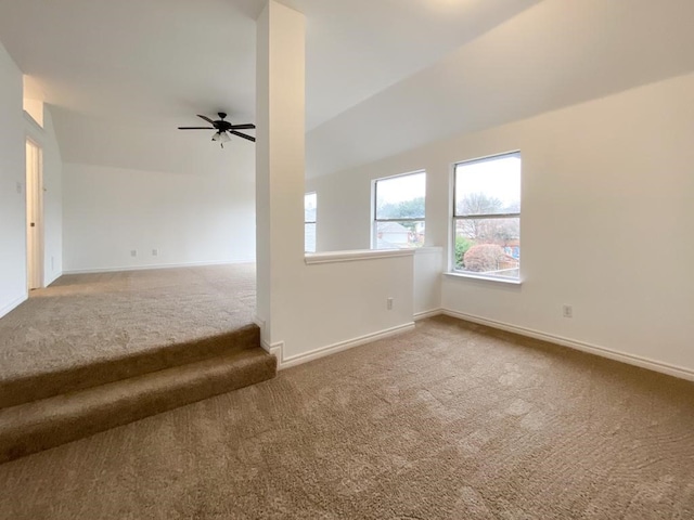 empty room featuring ceiling fan, baseboards, and carpet