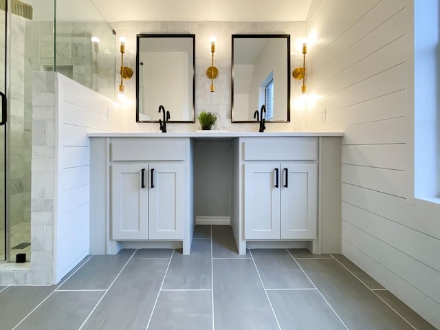 bathroom with tile patterned flooring, a stall shower, and vanity