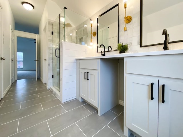 bathroom with double vanity, tile patterned floors, and a shower stall