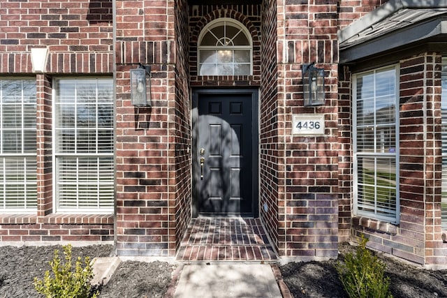 property entrance with brick siding