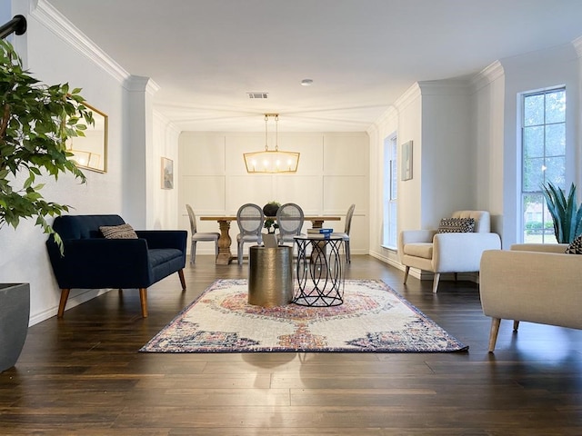 dining area featuring a chandelier, visible vents, crown molding, and dark wood-type flooring