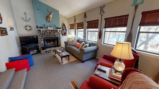 living room featuring carpet flooring, a stone fireplace, and lofted ceiling