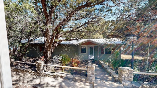 single story home with metal roof