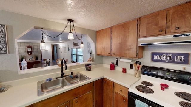 kitchen with under cabinet range hood, light countertops, electric range oven, a sink, and a textured ceiling