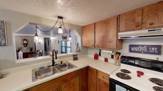 kitchen with a sink, light countertops, electric stove, under cabinet range hood, and a textured ceiling