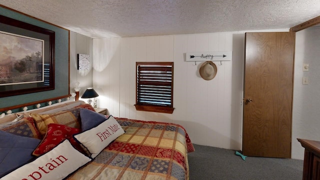 bedroom with a textured ceiling and carpet floors