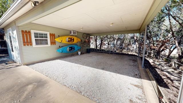 view of patio with a carport and an AC wall unit