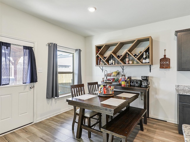 dining area featuring recessed lighting, light wood-type flooring, and baseboards