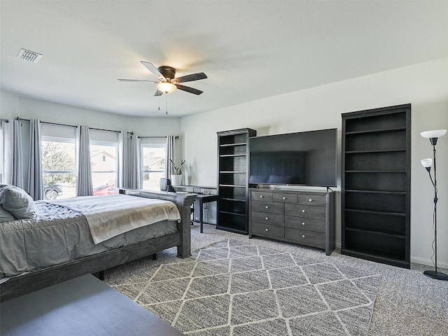 bedroom with carpet flooring, a ceiling fan, and visible vents