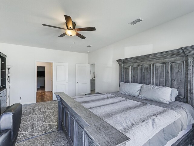 bedroom with visible vents, dark carpet, and a ceiling fan