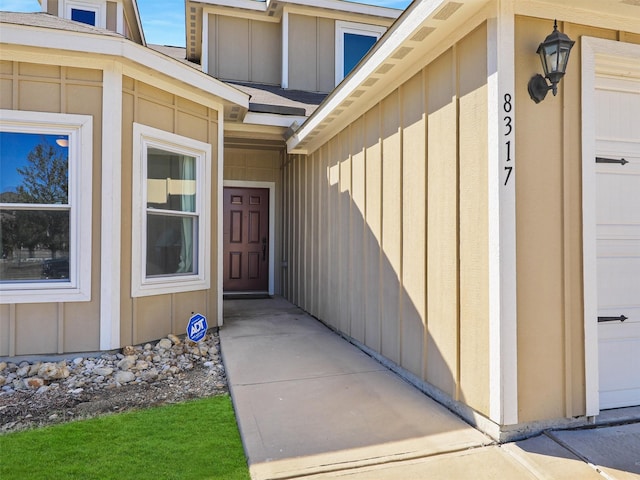 entrance to property featuring a garage and board and batten siding