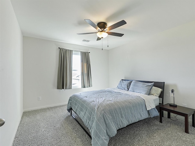 carpeted bedroom featuring visible vents, baseboards, and ceiling fan