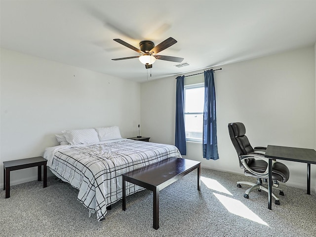 carpeted bedroom with visible vents, baseboards, and a ceiling fan