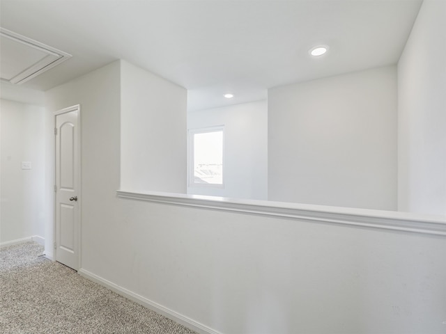 corridor with baseboards, recessed lighting, attic access, and carpet