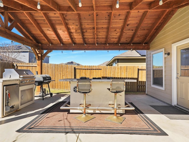 view of patio with grilling area and fence