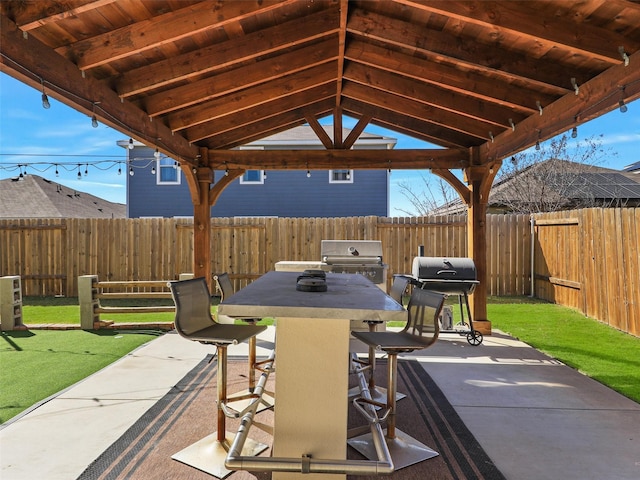 view of patio / terrace featuring area for grilling, outdoor dining space, and a fenced backyard