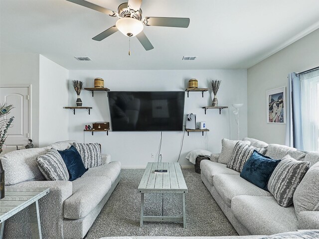 carpeted living area with visible vents and ceiling fan