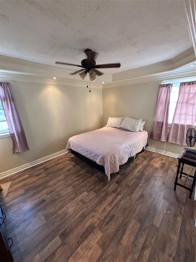 bedroom featuring ceiling fan, a textured ceiling, ornamental molding, and dark wood-style flooring