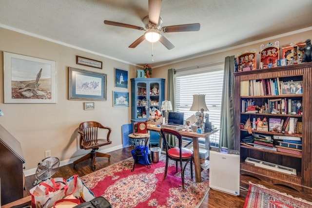 office with baseboards, wood finished floors, a ceiling fan, and ornamental molding