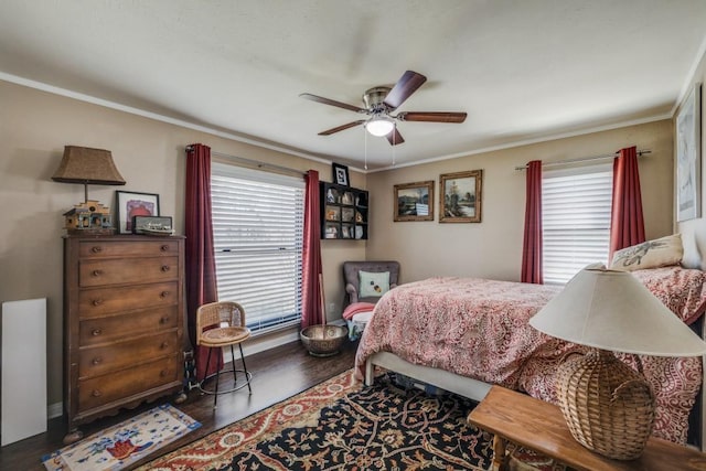 bedroom with ornamental molding, a ceiling fan, and wood finished floors