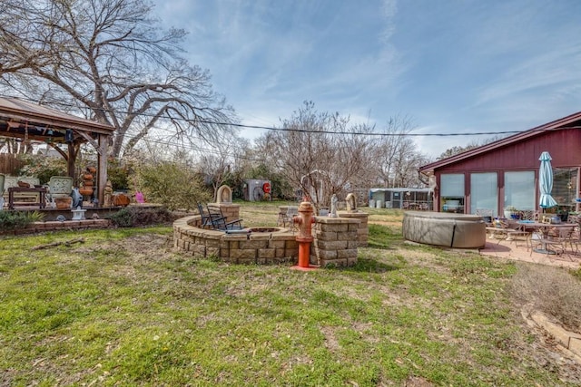 view of yard featuring a gazebo, a patio area, and an outdoor fire pit