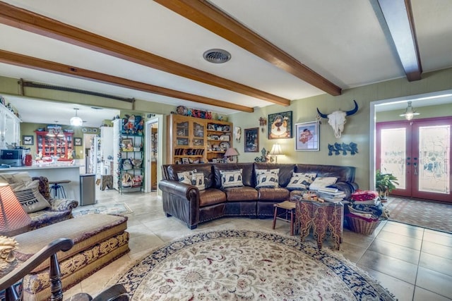 tiled living room with french doors, beam ceiling, and visible vents