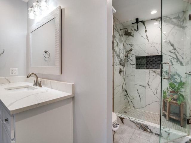 full bathroom with a marble finish shower, toilet, and vanity