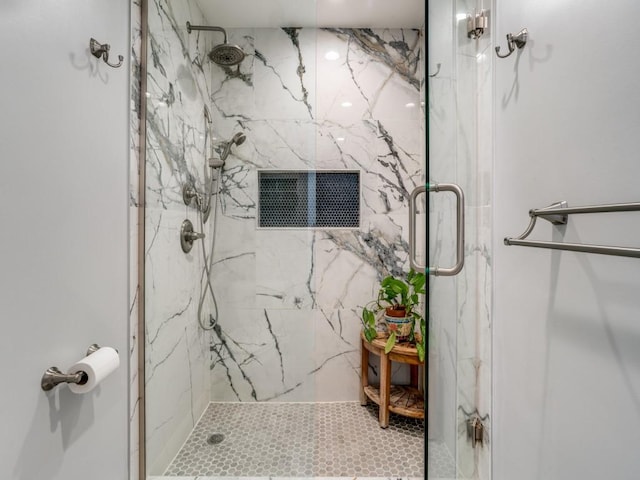 full bath with a marble finish shower