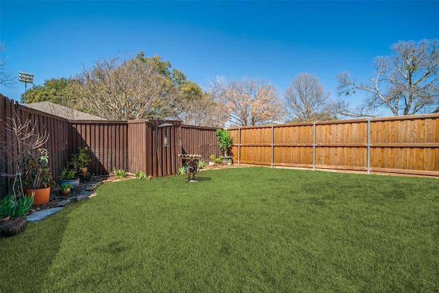 view of yard with a fenced backyard