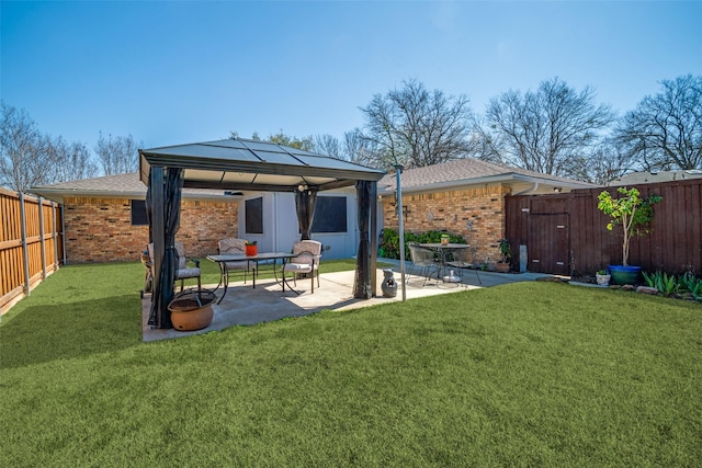 view of yard with a gazebo, a fenced backyard, and a patio