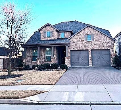 view of front of house featuring decorative driveway and a garage