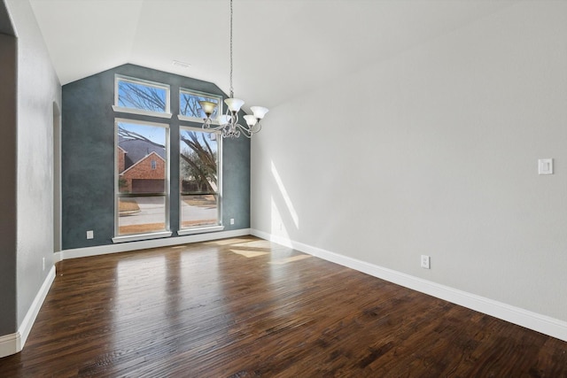 unfurnished dining area with baseboards, a notable chandelier, wood finished floors, and vaulted ceiling