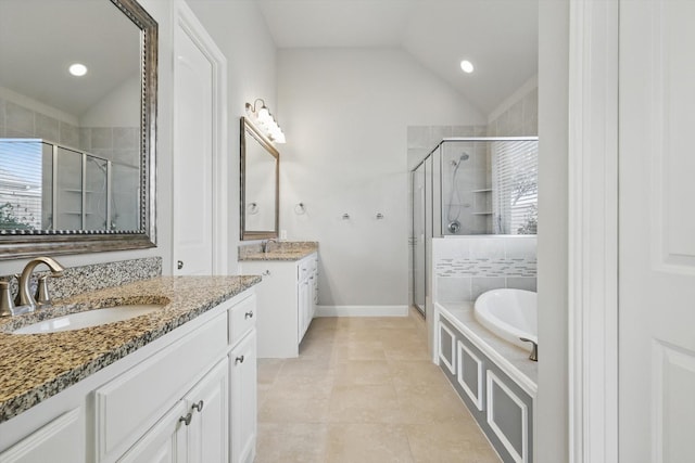 full bath featuring a garden tub, a stall shower, lofted ceiling, and a sink