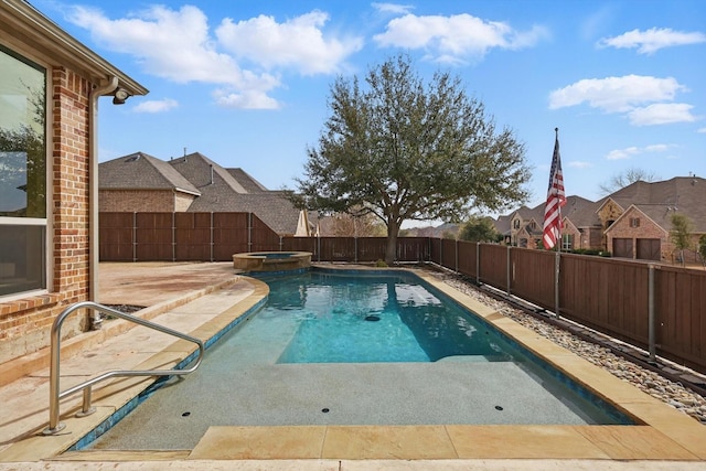 view of pool with a fenced backyard, a pool with connected hot tub, and a patio