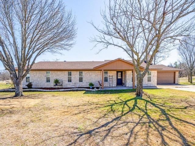 ranch-style home featuring a garage, a porch, a front lawn, and stone siding