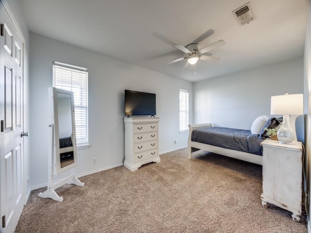 bedroom with visible vents, baseboards, carpet, and a ceiling fan