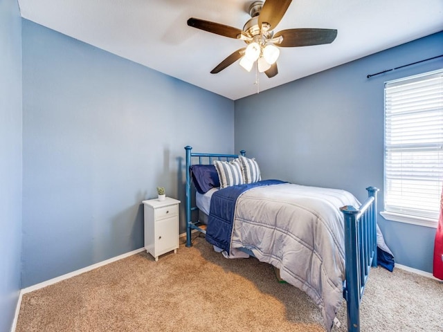 bedroom with multiple windows, carpet, and baseboards